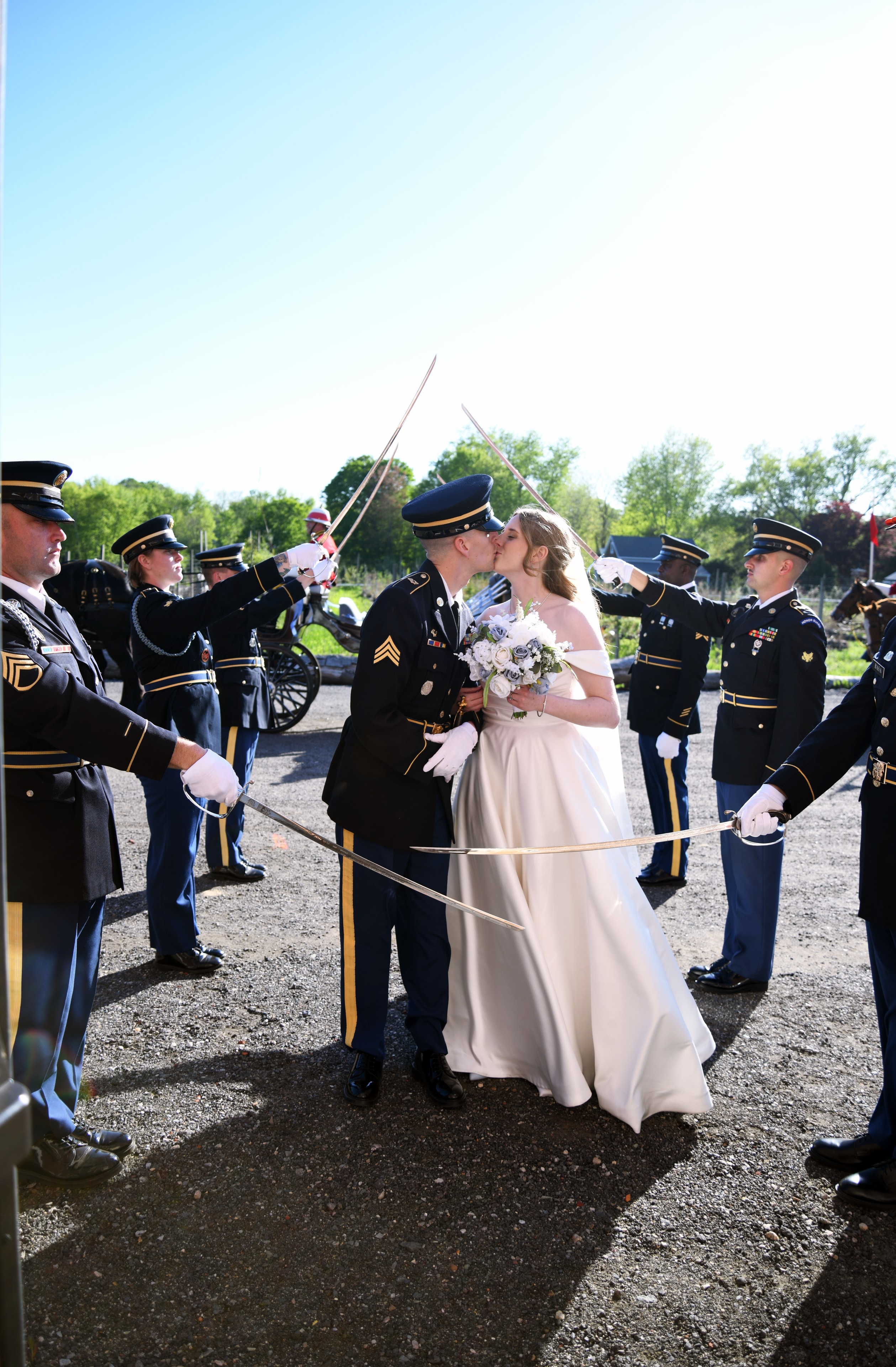 Military wedding ceremony sword arch kiss
