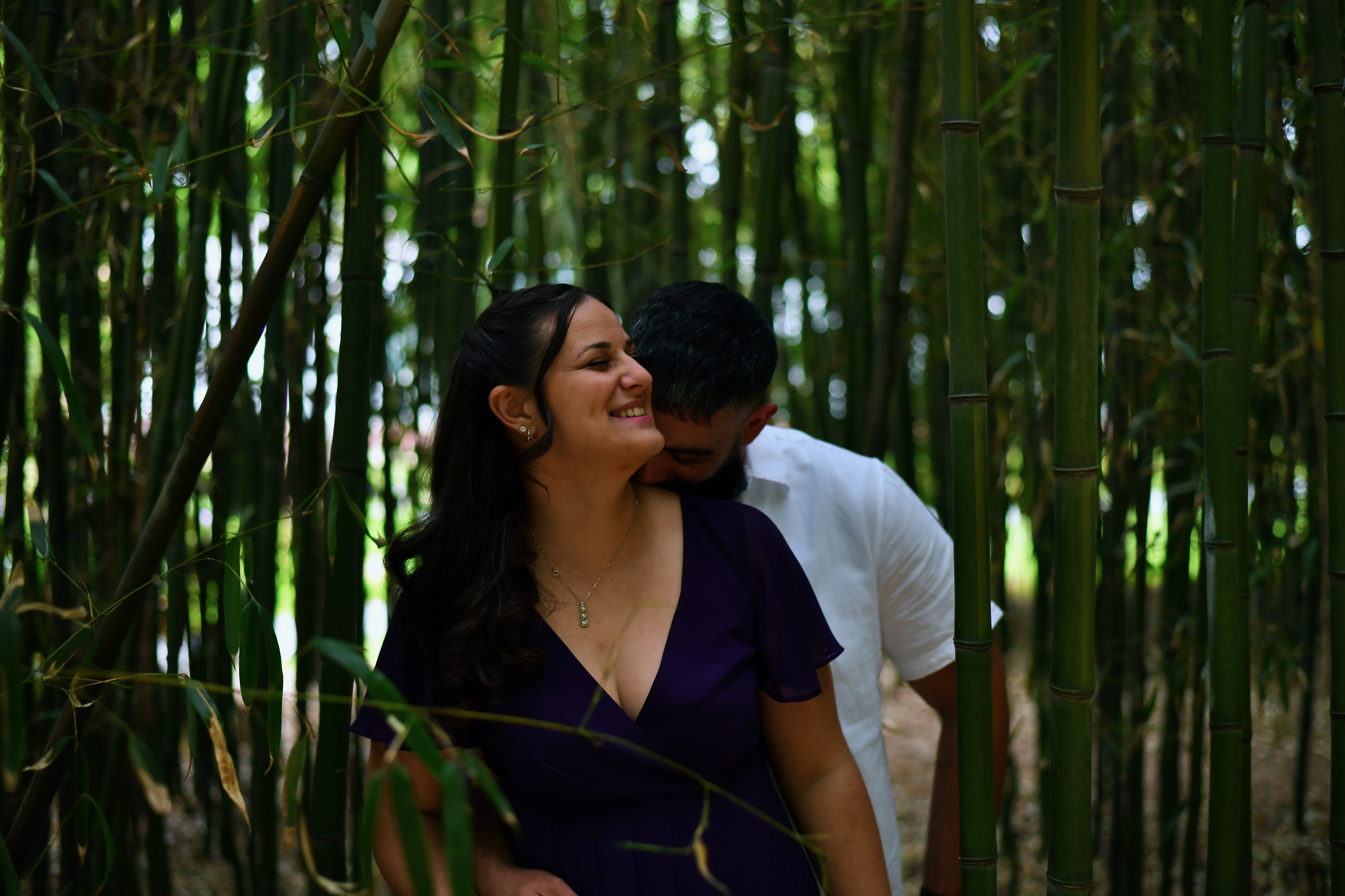 Couple embracing in a bamboo forest path
