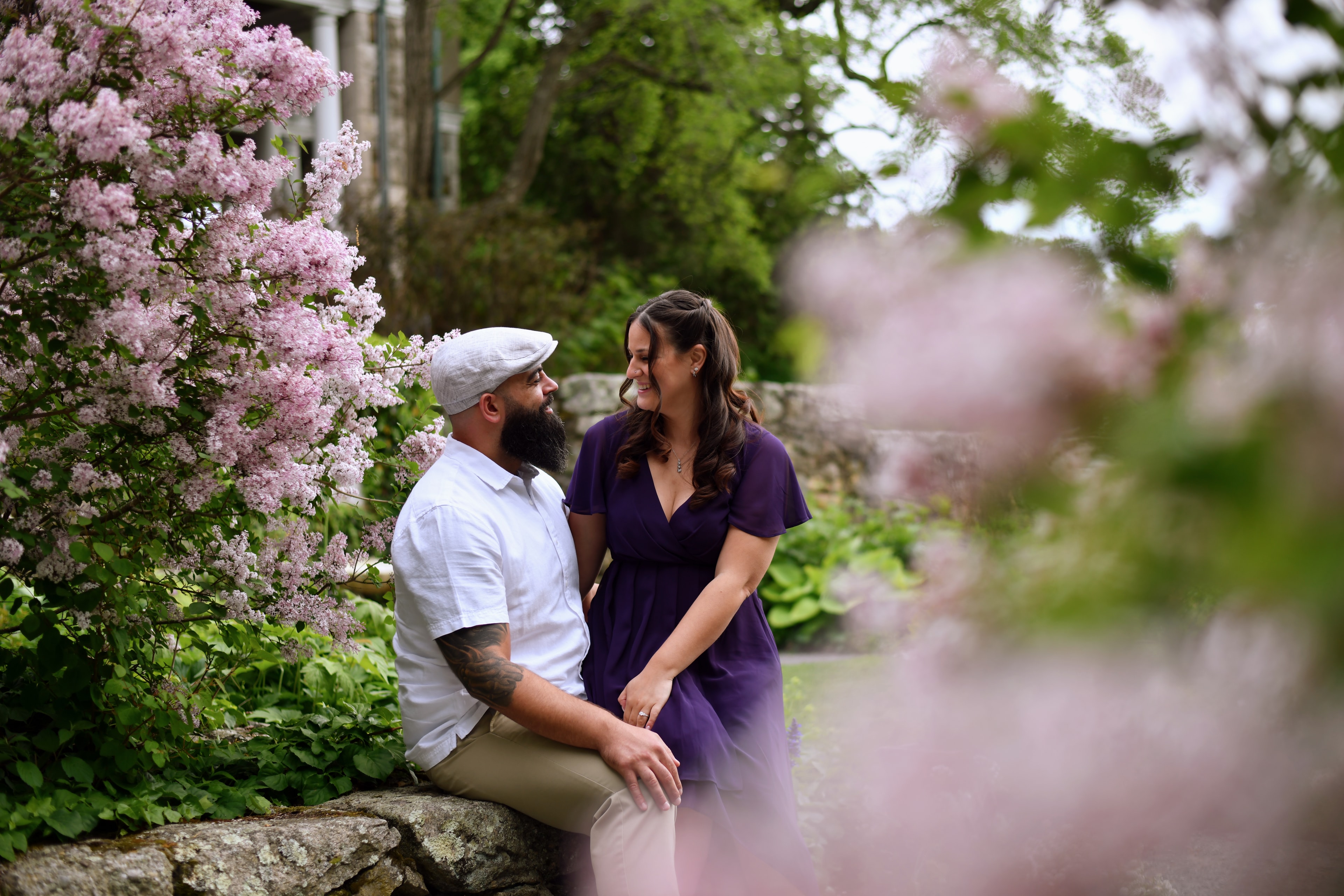 Couple posing by blooming lilac flowers