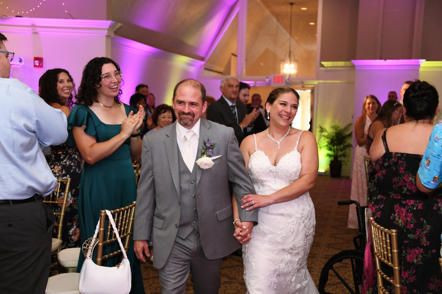 Bride and groom walking into reception to applause