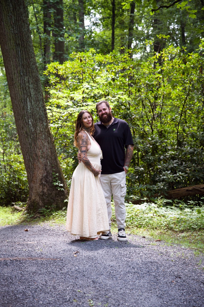 Couple standing together on a wooded garden path