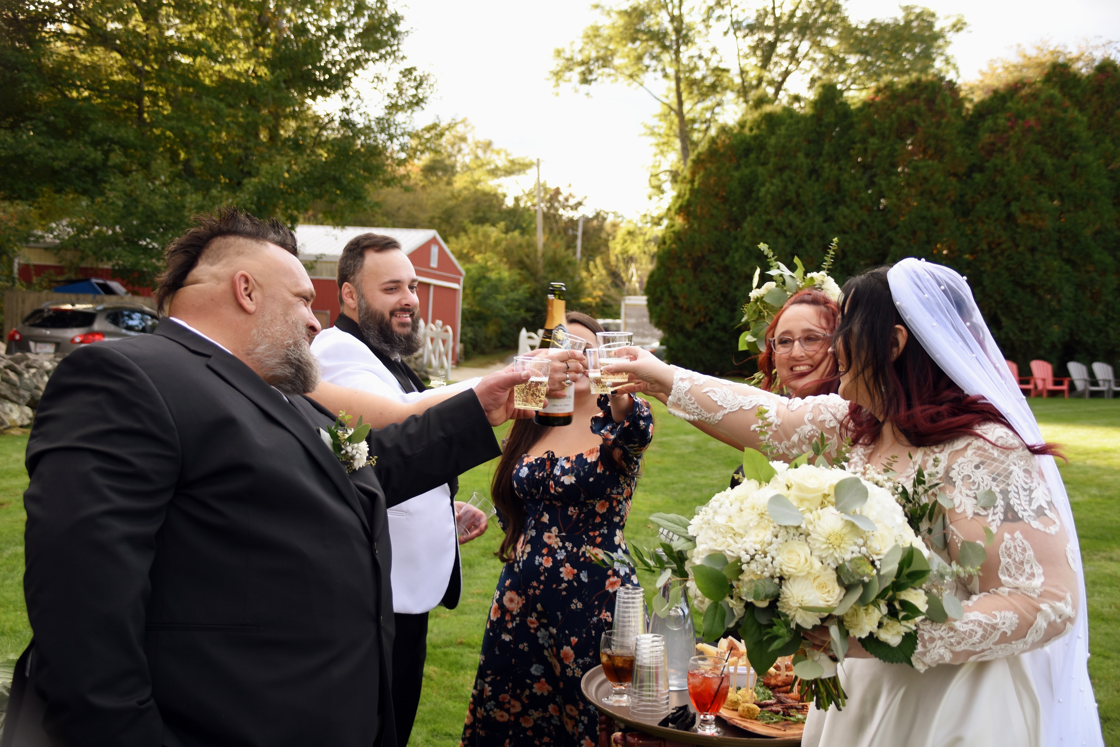 Wedding party toasting outdoors at reception