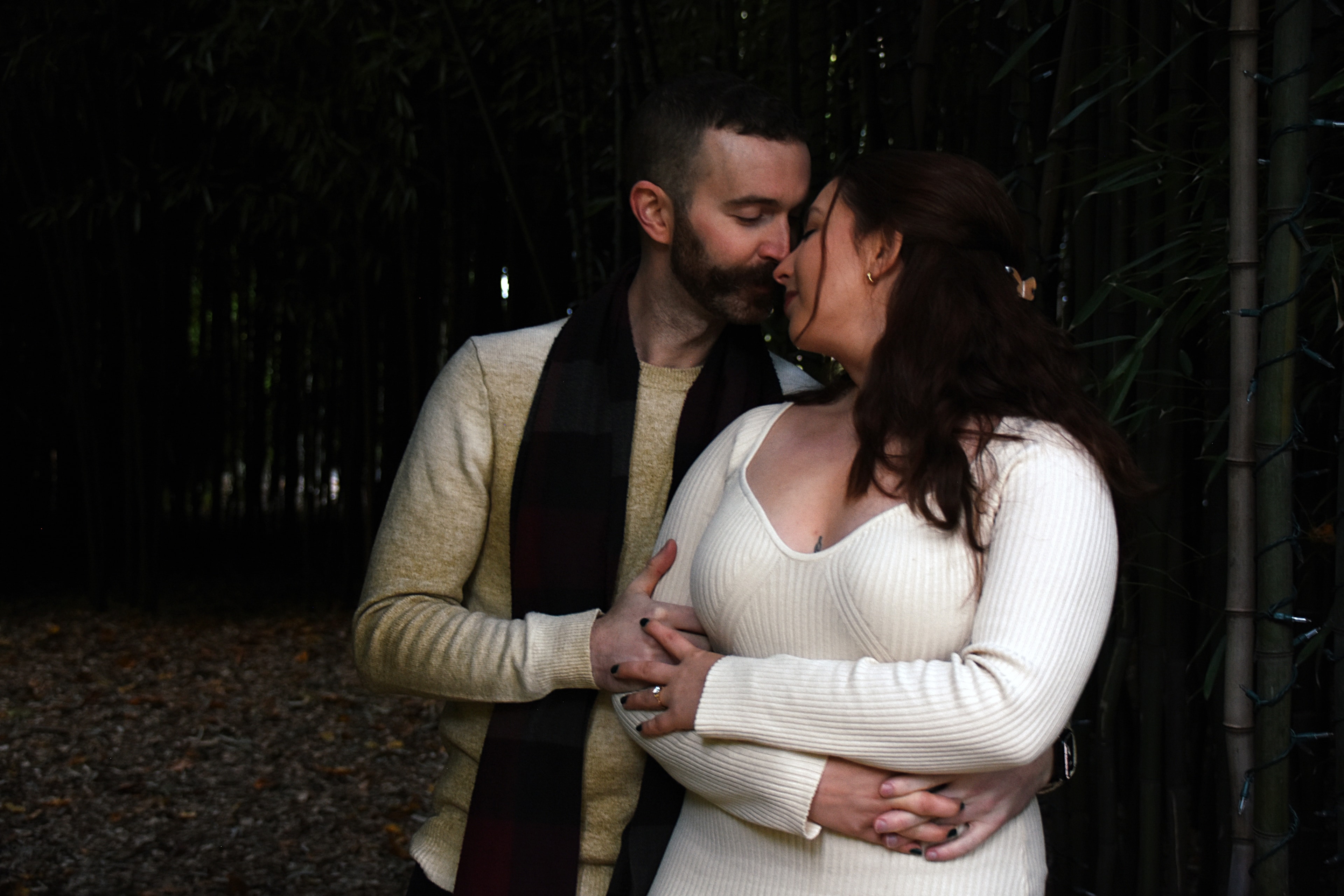 Couple kissing in dark forest path